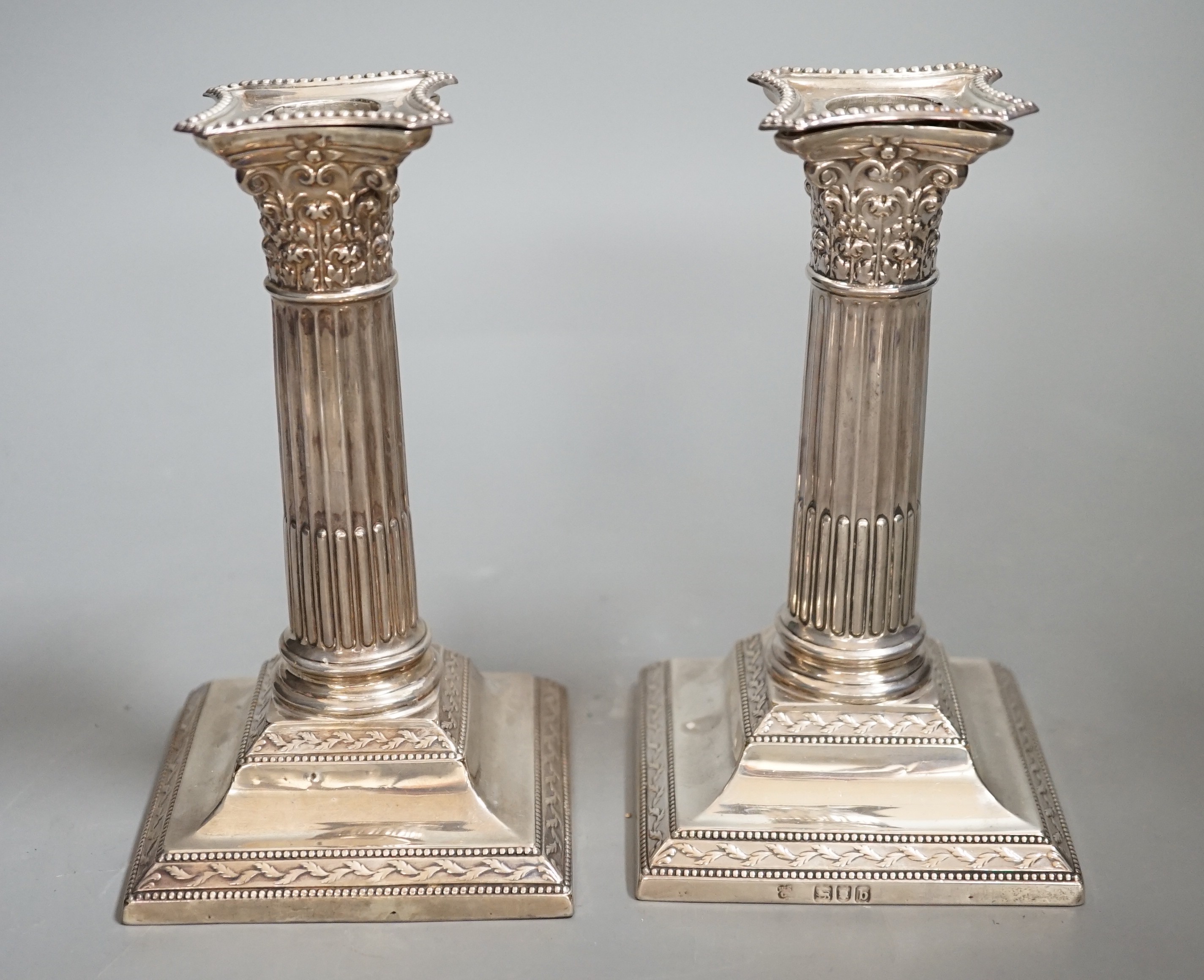 A pair of late Victorian silver Corinthian column dwarf candlesticks, W & G Sissons, London, 1897, 14.5cm, weighted.